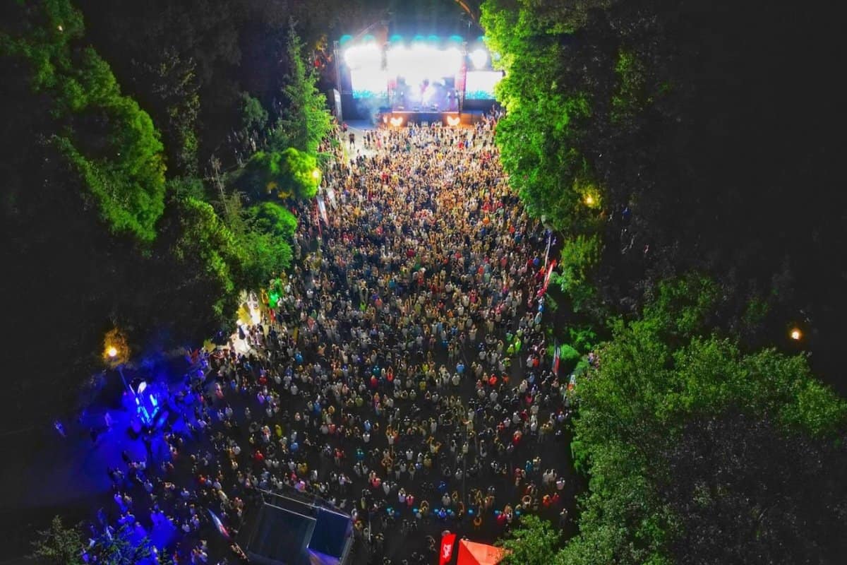Vibrant outdoor concert scene with a large crowd at Coca-Cola The Voice Happy Energy Tour 2025 in Pa.